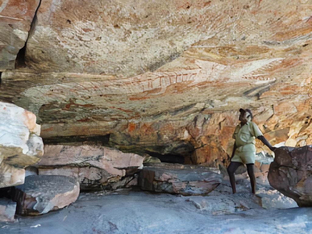 Traditional Owner Charlie Mangulda with a Rainbow Serpent in Arnhem Land, Northern Territory.